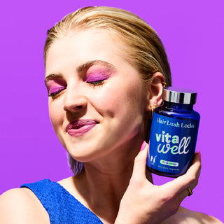 Person holding bottle of hair lush locks vitamins