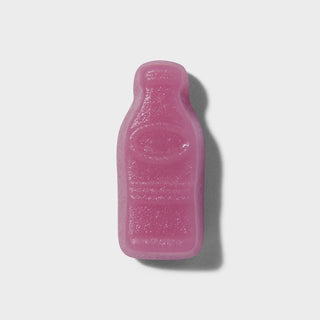 Pink bottle-shaped gummies on a light grey background