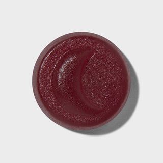 Round dark red gummies on a light grey background