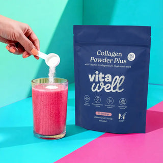 Collagen powder being added to a glass with vita well packaging on a colourful background
