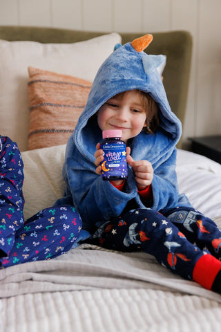 image of child holding a bottle of Vitawell little dreamers vitamins